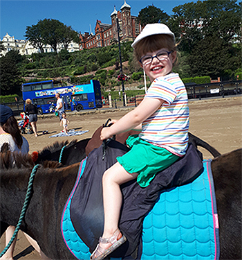 Gracie riding a horse