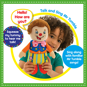 A young child holding a Mr Tumble doll